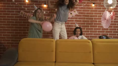 Crazy-friends-surprising-birthday-person-appearing-from-sofa