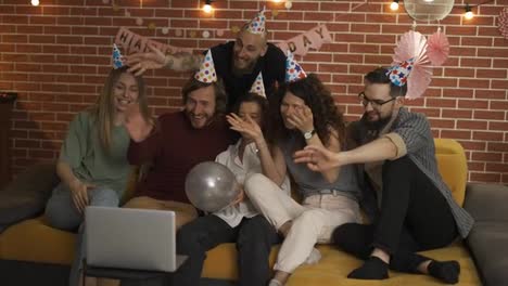 Group-of-people-at-home-celebrating-birthday-wearing-party-hats,-gasping-in-surprise,-having-video-call