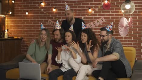 Cheerfur-friends-at-home-celebrating-birthday-having-video-call-by-laptop