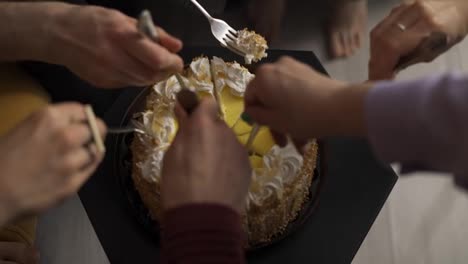People-grabbing-cake-slices-using-forks