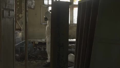 Worker-in-protective-suit-inside-the-ruined-building
