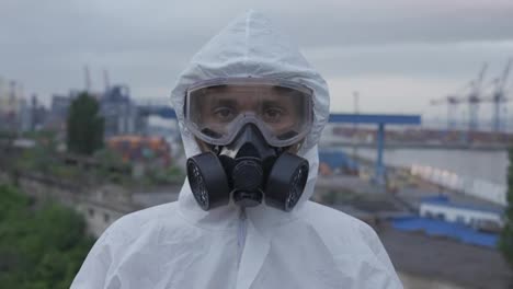 Portrait-shot-worker-put-off-the-protective-mask-and-respirator-outdoors