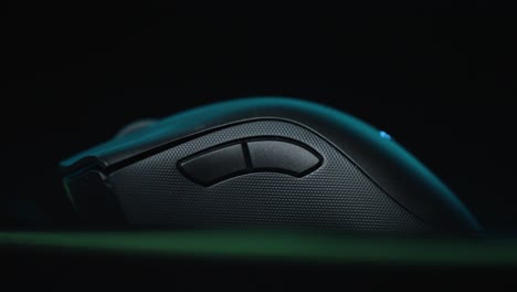 Close-up-of-gaming-mouse-with-RGB-lights-against-a-black-background
