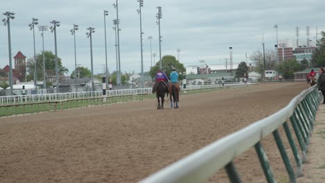 Kentucky-Derby-Horses-and-Jockeys-walking-down-the-track-at-Churchill-Downs