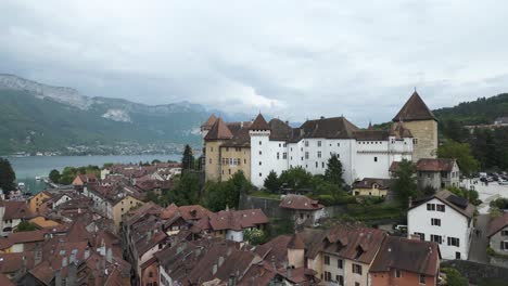 Chateau-d'Annecy-Medieval-Castle-overlooking-Annecy-Old-Town,-Aerial-with-Copy-Space