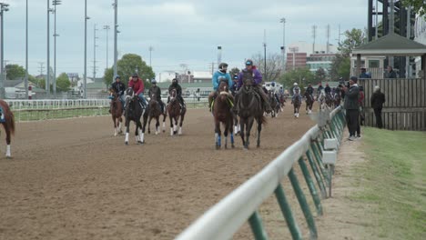Kentucky-Derby-Horses-and-Jockeys-walking-down-the-track-at-Churchill-Downs