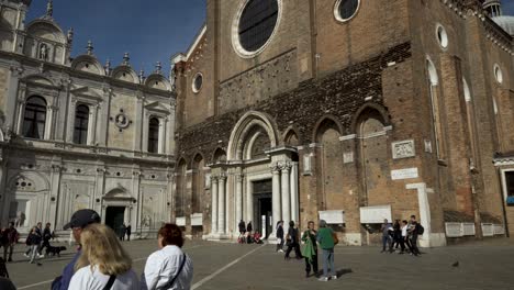 San-Zanipolo-Church-View-From-Across-The-Piazza-In-Venice-With-Tourists-Walking-Past