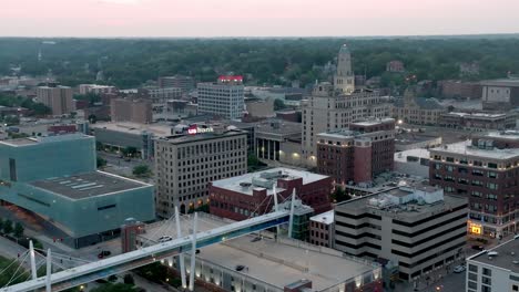 Downtown-Davenport,-Iowa-skyline-during-sunset-with-drone-video-moving-in