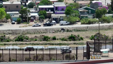 Aerial-view-of-Border-Patrol-SUV-and-Humvee-Military-grade-vehicle-at-border-of-Mexico-and-USA