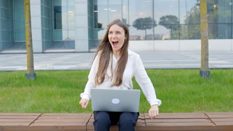 Entrepreneur-woman-burst-in-happiness-after-making-great-deal-on-her-laptop