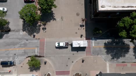 Downtown-Rock-Island,-Illinois-with-drone-video-overhead-intersection-with-pick-up-truck-hauling-trailer