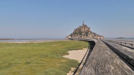 View-from-the-bridge-to-the-medieval-abbey-of-Mont-Saint-Michel-in-France