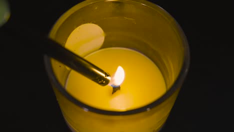 High-angle-of-a-candle-being-lit-in-slow-motion