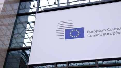 European-Council-name-banner-at-the-EU-headquarters-in-Brussels,-Belgium---Panning-shot