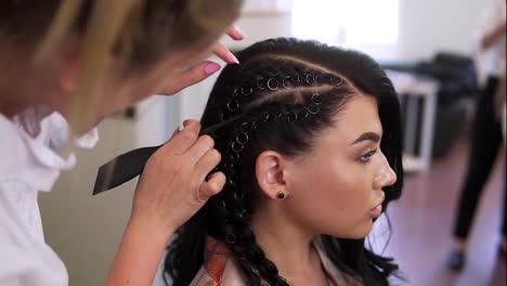 Hairdresser-created-complicated-evening-at-barbershop-salon.-Close-up,-she-corrects-hair-braids-and-ornaments.-Slow-motion