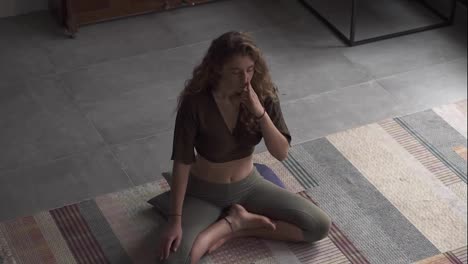 Alternate-nostril-breathing-technique-in-lotus-pose,-high-angle-view