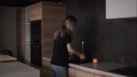 Hygiene,-health-care-and-safety-concept---woman-washing-fruits-and-citrus-in-kitchen-at-home