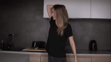 The-girl-dances-sensually-in-the-kitchen-with-modern-loft-interior