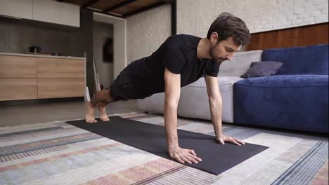 Man-holding-hands-on-floor-and-doing-push-up-exercise