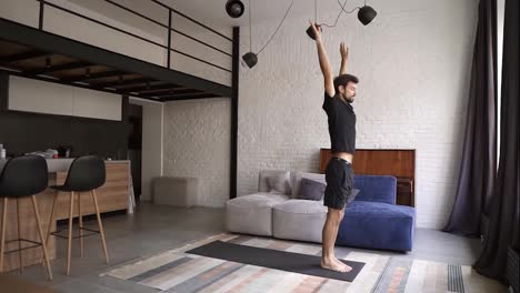 Young-healthy-man-practice-yoga-on-mat,-performing-cobra-asana