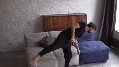 Man-in-slowmo-falling-on-a-couch-with-smartphone,-scrolling-various-gestures,-like-swiping-and-scrolling