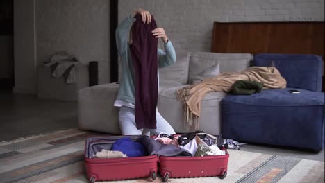 Portrait-of-a-a-woman-in-a-hotel-room-make-out-clothes-from-a-suitcase
