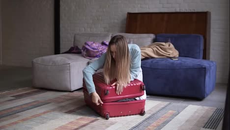 Woman-closing-and-zipping-suitcase,-getting-ready-for-road-trip-preparing-luggage-for-vacation