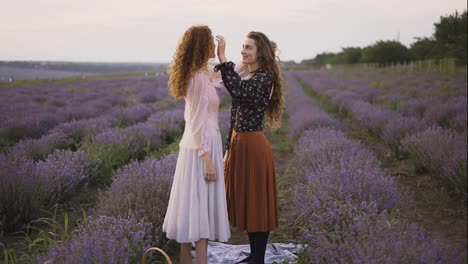 Two-sensual-women-among-a-lavender-field-enjoying-time-together