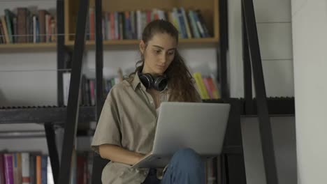Charming-female-student-making-research-for-startup-project-using-laptop