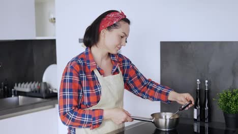Woman-measures-the-temperature-in-a-saucepan-with-syrup