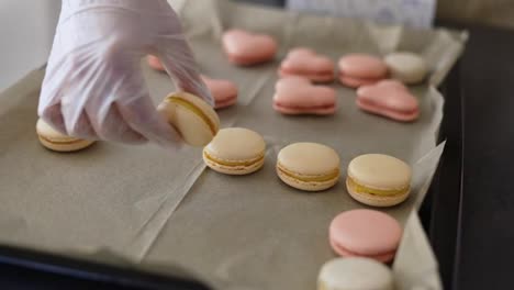Female-hands-putting-filled-macaroons-in-a-tray