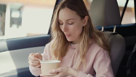 Woman-having-her-meal-inside-the-parked-car