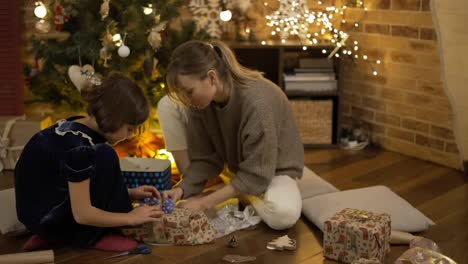 Mother-and-daughter-wrapping-creative-Christmas-presents-together