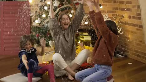 Mother-and-daughters-playing-having-fun-laughing,-throwing-white-confetti-at-home
