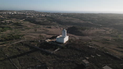 Cinematic-Aerial-view-of-Lighthouse-in-Gozo-birds-flying