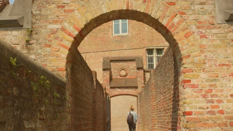 Person-Walking-At-The-Passage-Towards-The-Exit-In-Saint-John’s-Hospital-Museum-In-Bruges,-Belgium