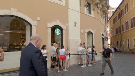 People-Waiting-in-Line-Outside-Starbucks-in-Rome,-Italy-on-Hot-Summer-Day