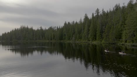 Two-Kayakers-paddling-on-flat-calm-lake
