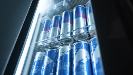 Handheld-footage-of-Red-Bull-cans-in-a-Red-Bull-fridge-in-a-dark-environment