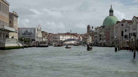 Water-Taxis-Sailing-Past-Along-The-Grand-Canal-In-Venice-Leaving-Wake-In-Water