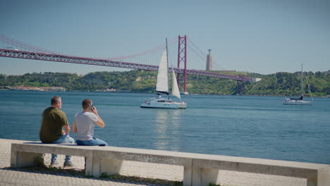 25-April-Bridge-In-Belem-Lisbon-Sail-Boat-Passing-By
