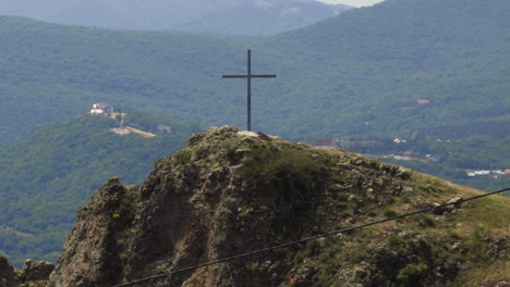 Wooden-Cross-On-Top-Of-Rugged-Mountain-In-The-Countryside-Of-Georgia