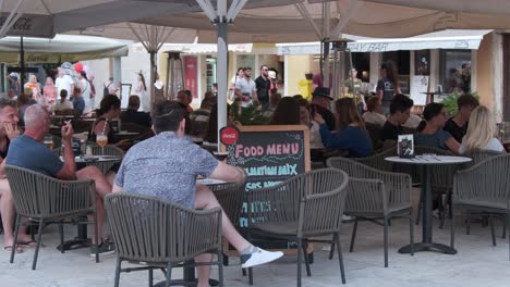 Zadar-old-town-square-with-restaurant-terrace-and-people-sitting,-enjoying