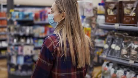 Young-woman-carries-a-cart-with-groceries-in-the-supermarket-during-the-quarantine-period