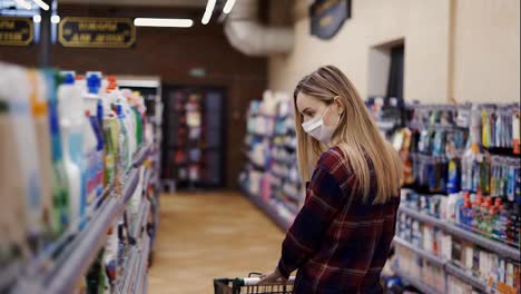 Woman-choosing-detergent-at-a-household-goods-in-the-store