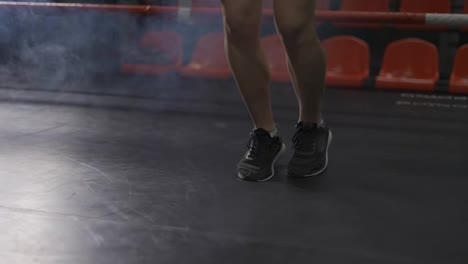 Close-up-of-young-female-s-legs---boxer-jumping-on-the-skipping-rope-on-ring