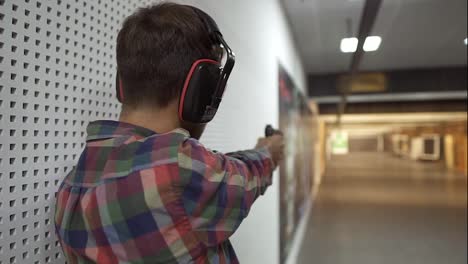 Rare-view-of-a-man-practicing-with-gun-in-the-shooting-range