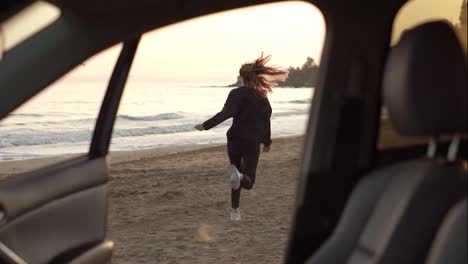 Woman-in-slow-motion-running-from-car-through-the-sea-beach,-feel-exciting-on-sea-beach