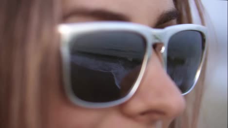 Sea-waves-reflected-in-the-sunglasses-of-a-beautiful-blonde-on-the-beach