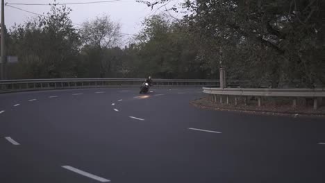 A-man-riding-on-a-motorcycle-on-a-turn-clings-to-the-asphalt,-sparks-fly